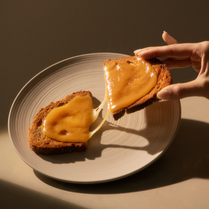 toast on a plate with hand holding toast