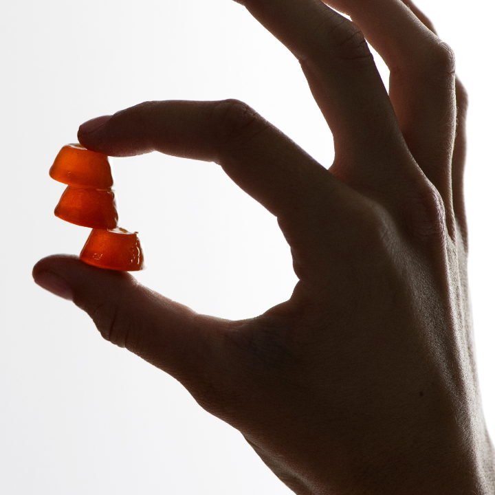 drops of honey pinched in hand