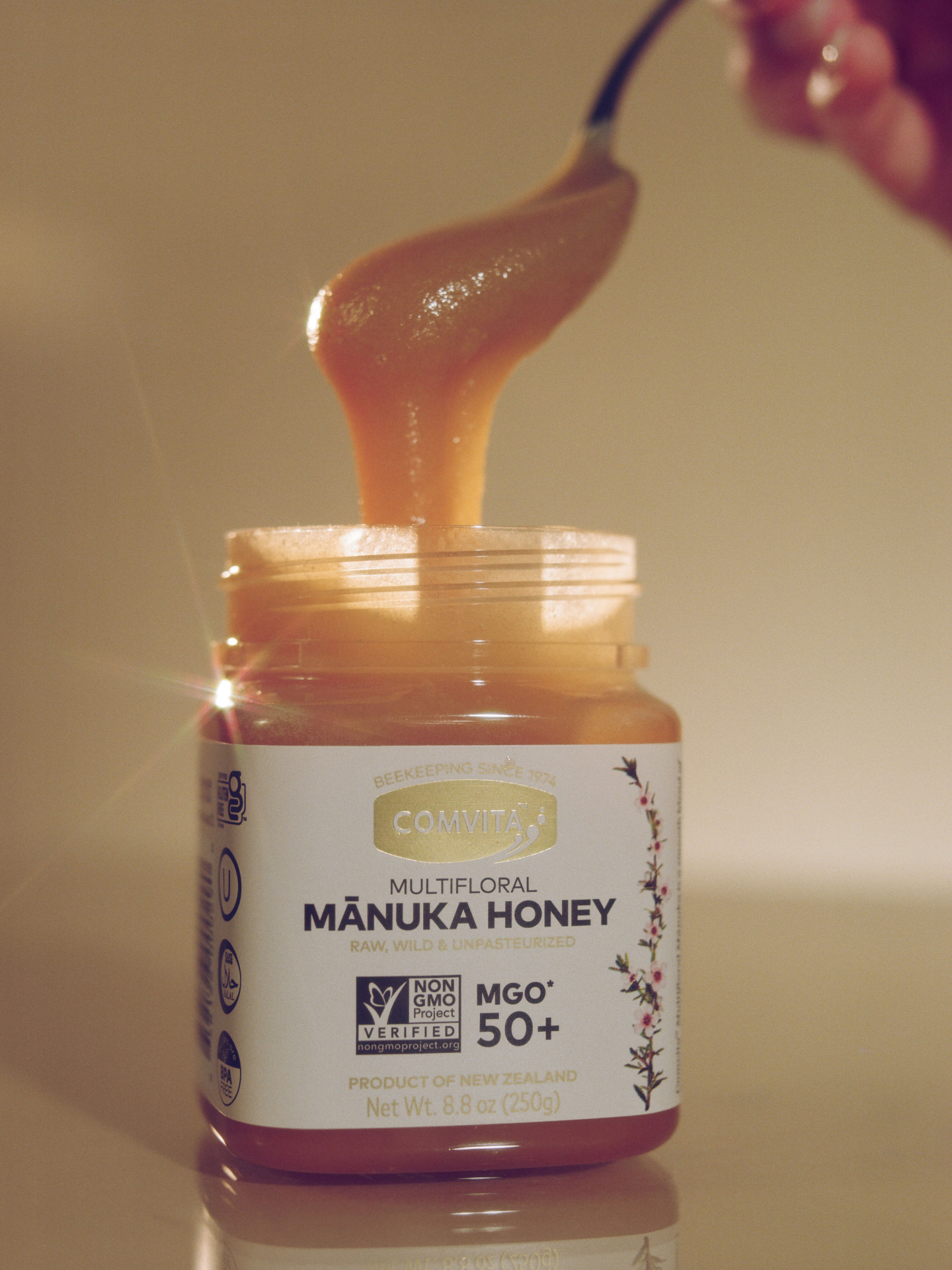 spoonful of honey coming out of jar