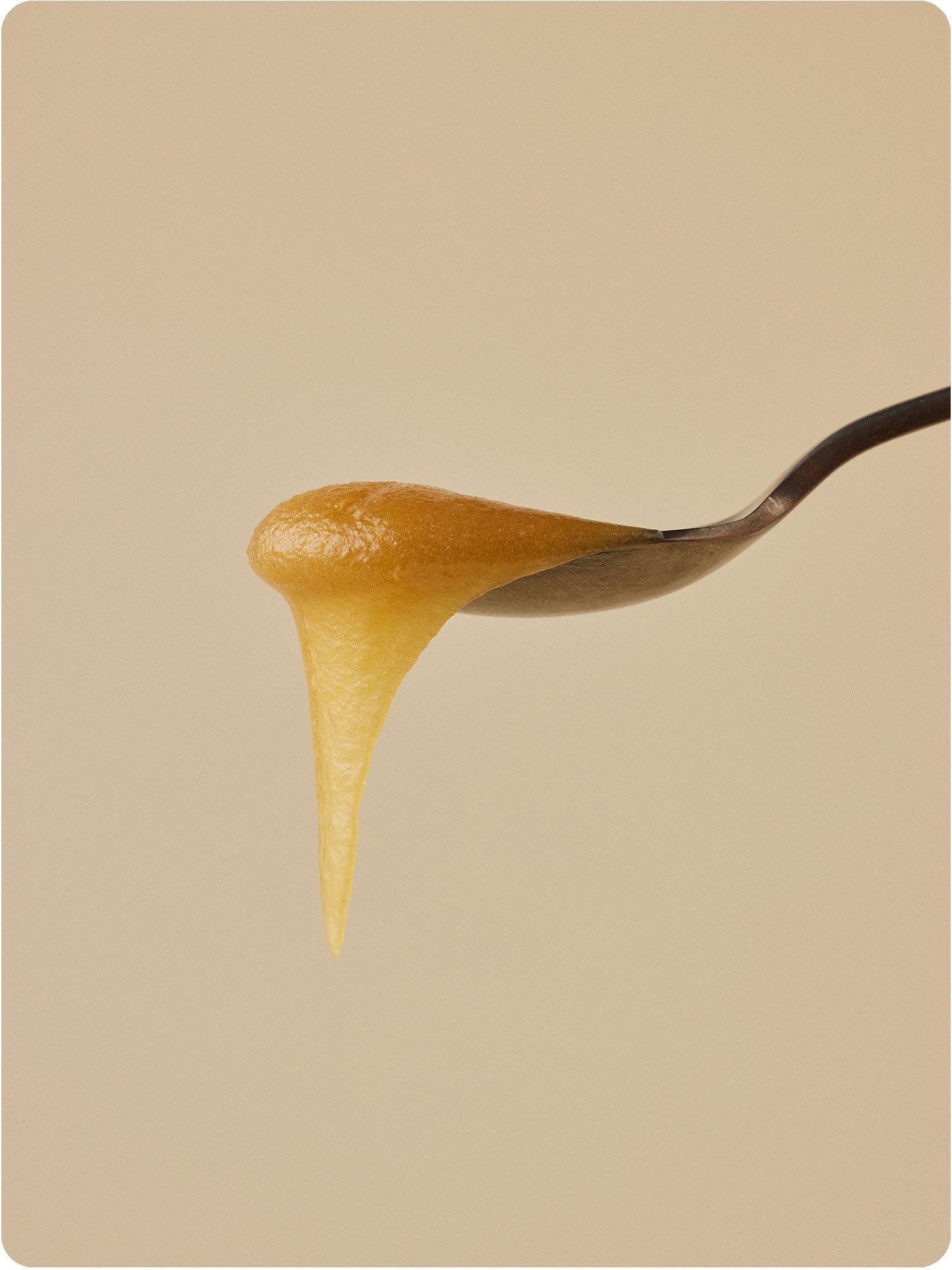 manuka honey dripping off a spoon