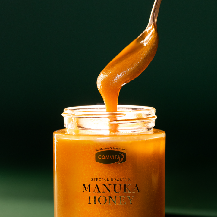 spoonful of honey coming out of jar