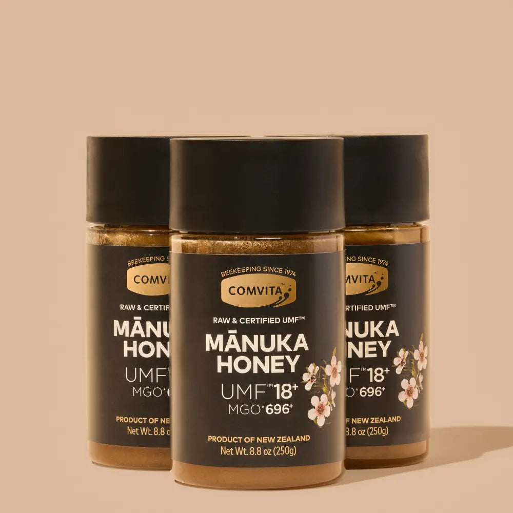 Three jars of Manuka Honey on a beige background