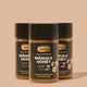 Three jars of Manuka Honey on a beige background