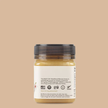 Jar of honey with a label on a beige background