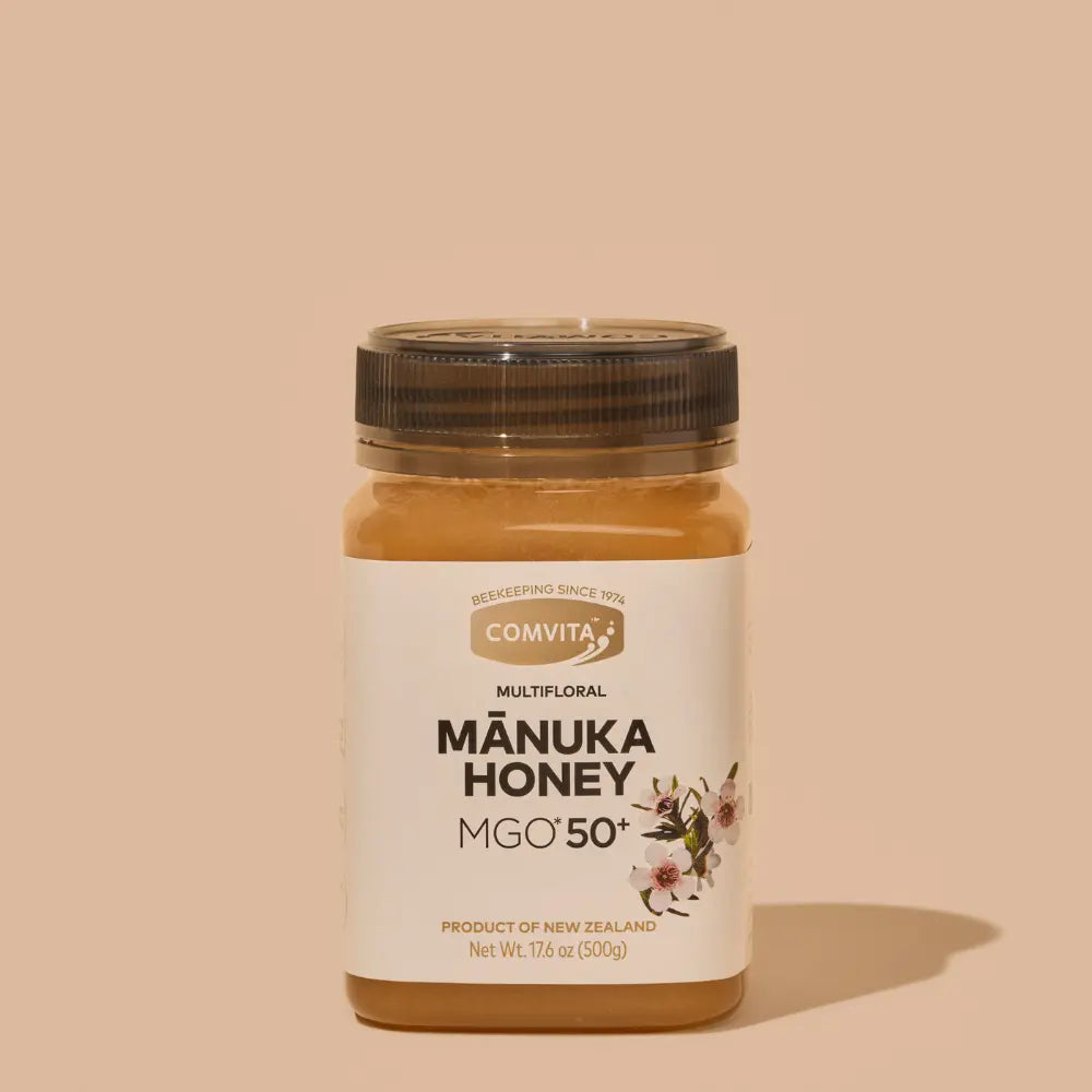 Jar of Manuka Honey with Comvita label on a beige background