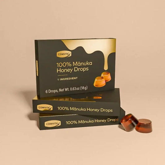 Comvita 100% Manuka Honey Drops packaging on a beige background