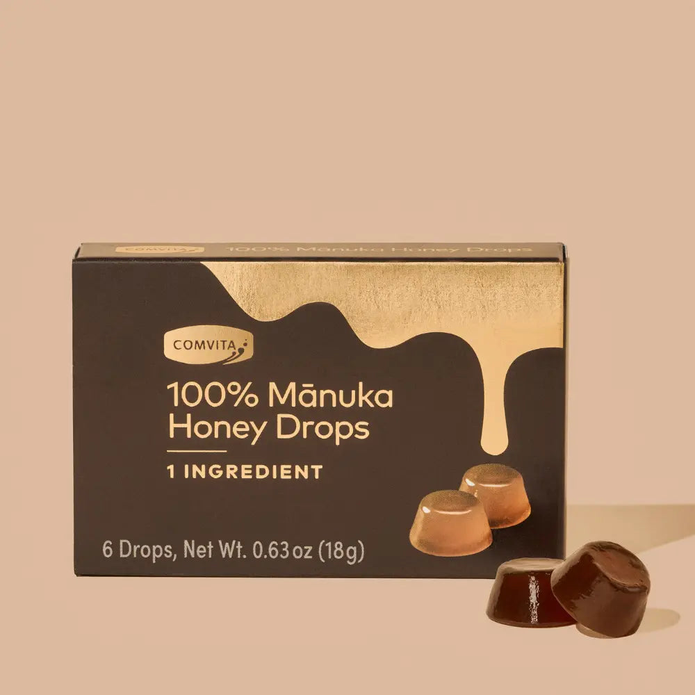 Box of Comvita 100% Manuka Honey Drops on a beige background