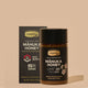 Jar of Comvita Manuka Honey with box packaging just behind on it on a beige background. 