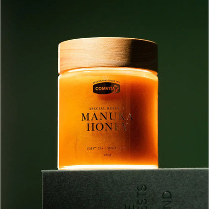 Jar of Comvita Manuka Honey on a dark background
