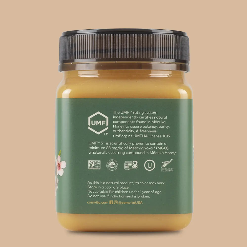 Jar of honey with a green label on a beige background