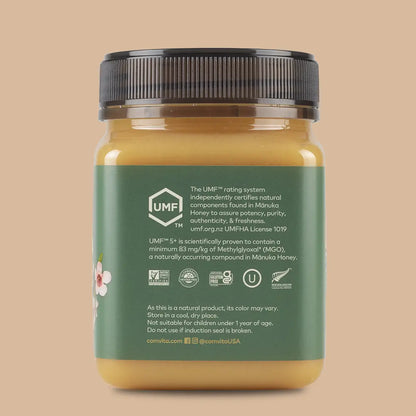 Jar of honey with a green label on a beige background