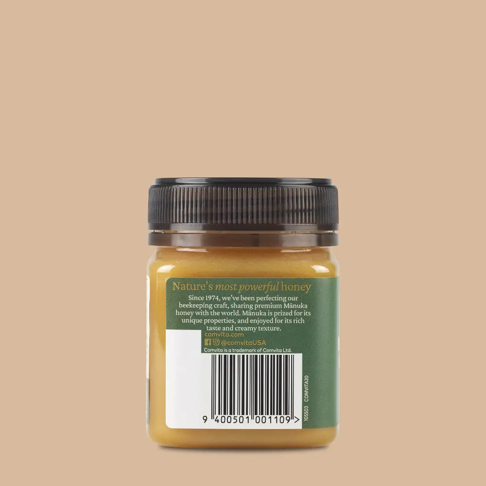 Jar of honey with a green label on a beige background