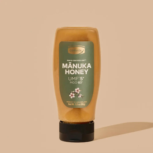 UMF 5 Comvita Manuka honey bottle with green label on a beige background