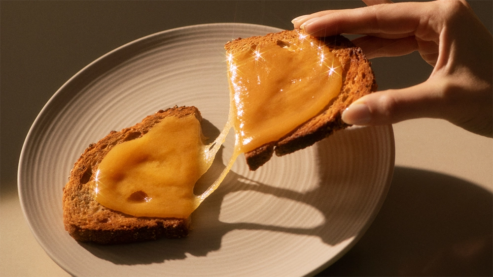 toast on a plate with hand holding toast